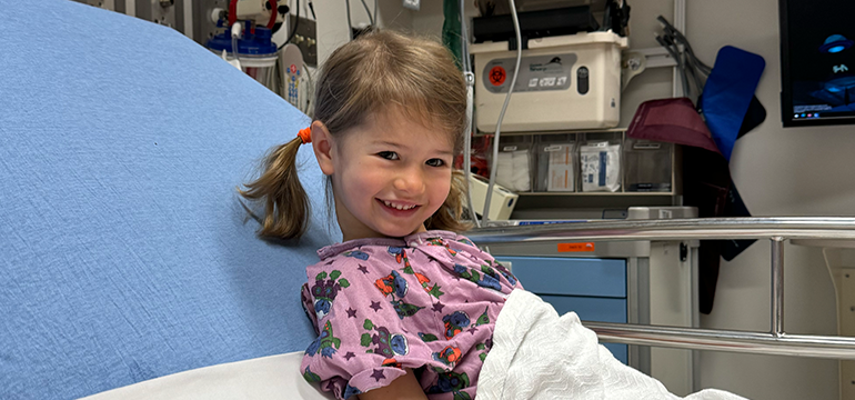 Charlie smiles in her patient bed