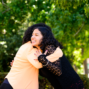 A teen and her doctor hug