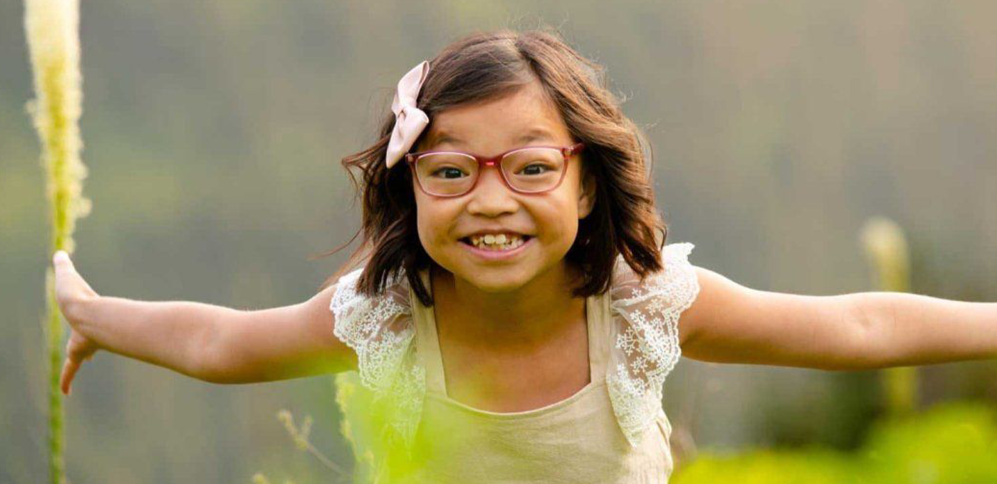 a young patient smiles outside