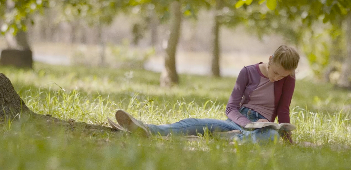 Sage in a park reading