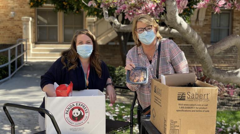 Panda Express employees in masks tabling