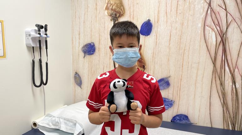 a young patient enjoys a stuffed panda toy