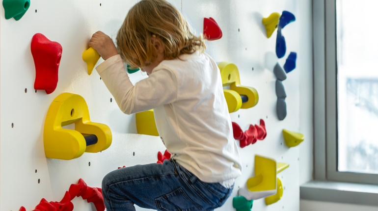a child on a climbing wall