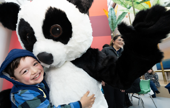 Panda Cares Center of Hope Event smiling boy with panda bear