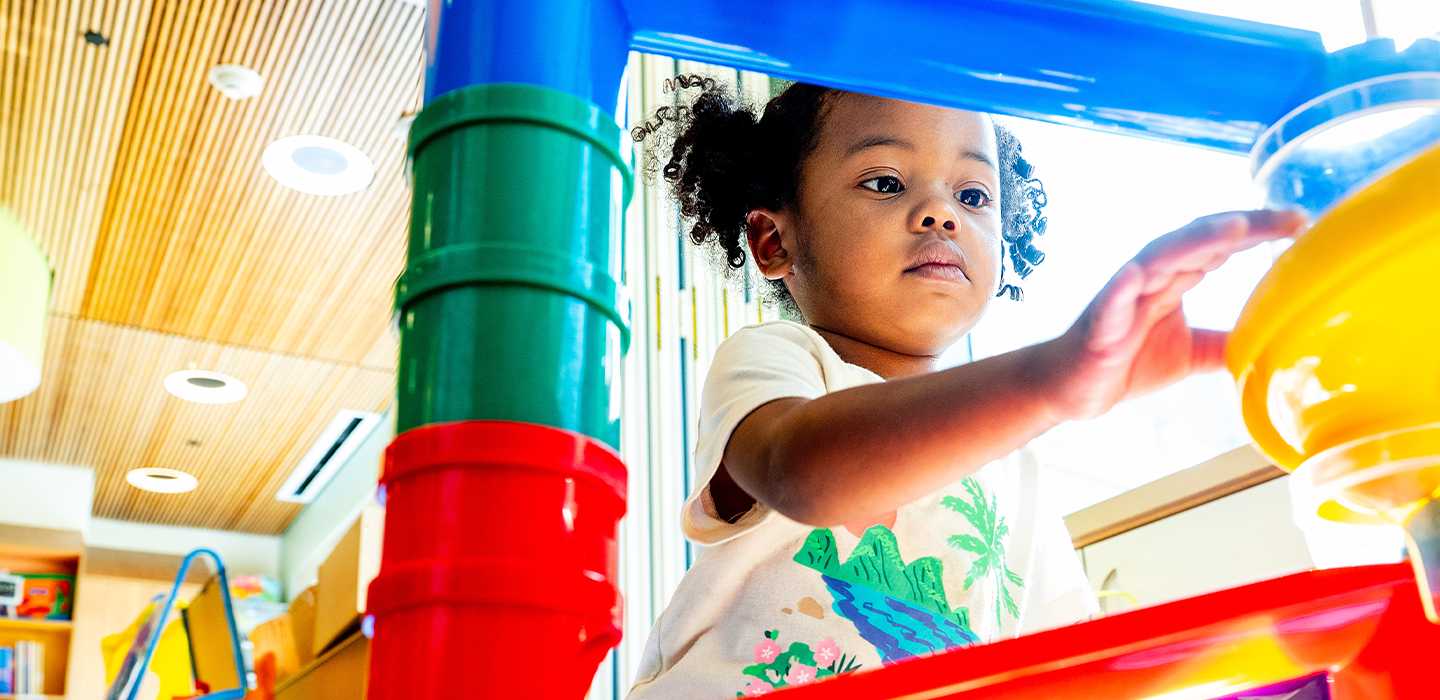 A child plays with colorful building blocks