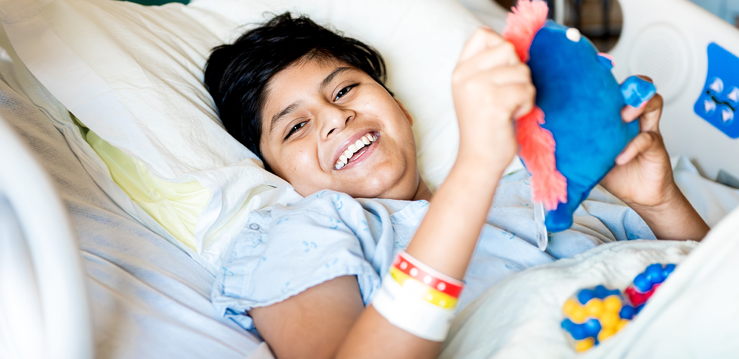 a happy patient smiles in their bed